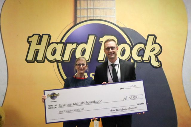 Hard Rock representatives presenting a $1,000 donation check to Save the Animals Foundation