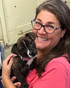 Dian Isler holding a puppy