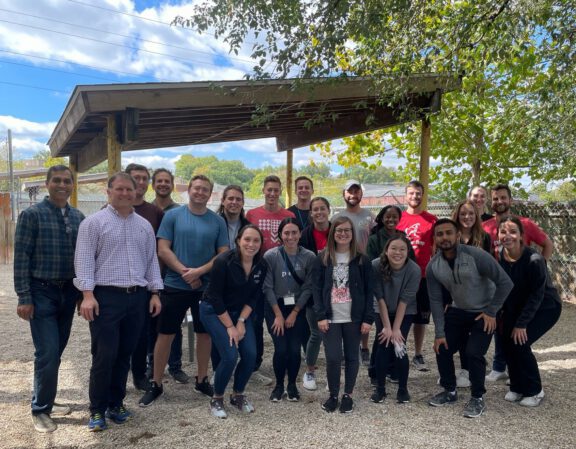 Group of Save the Animals Foundation volunteers posing together outdoors at the shelter.
