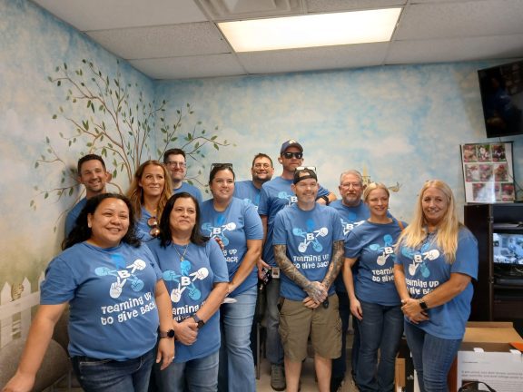 group of BlueStar employees smiling at STAF